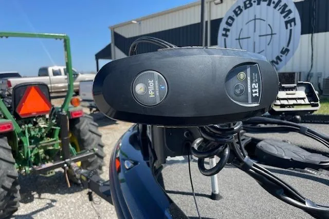 Slide: The Image of 2018 Nitro Z21 boat with iPilot trolling motor, parked near a green tractor. - 7