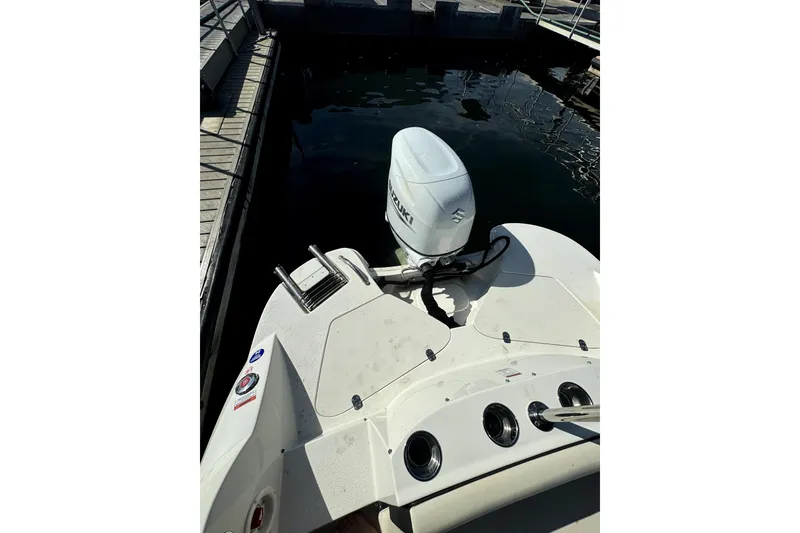 Slide: The Image of 2022 Stingray SC192 boat with Suzuki outboard motor docked at marina. - 10