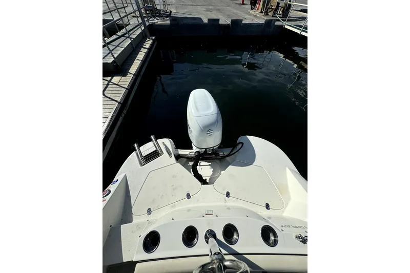 Slide: The Image of 2022 Stingray SC192 boat with outboard motor docked at marina. - 11