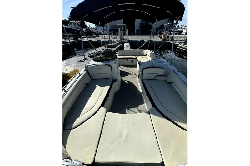 Slide: The Image of 2022 Stingray SC192 boat interior with spacious seating and canopy at dock. - 15