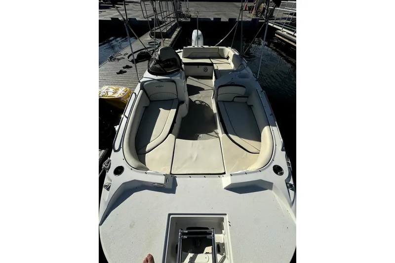 Slide: The Image of 2022 Stingray SC192 boat with beige seating, docked at marina. - 17