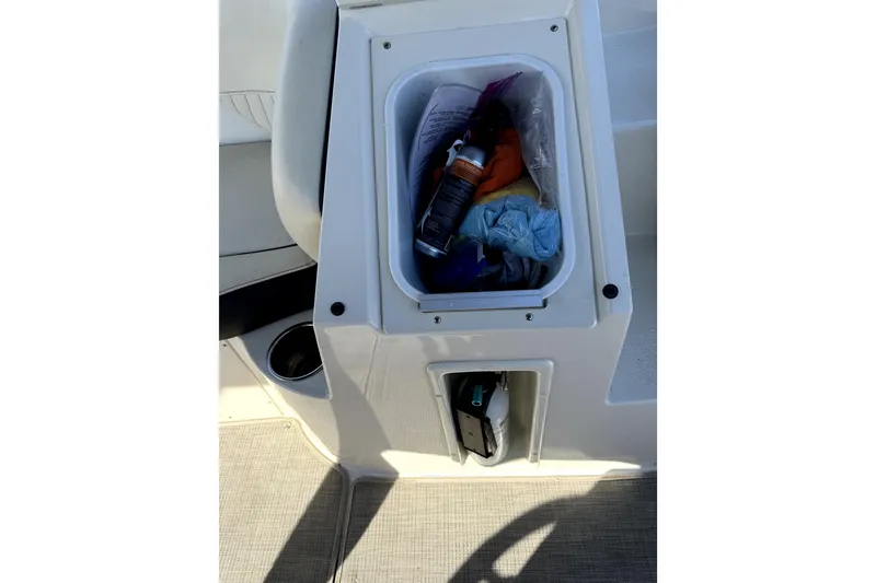 Slide: The Image of Storage compartment on a 2022 Stingray SC192 boat with cleaning supplies. - 21