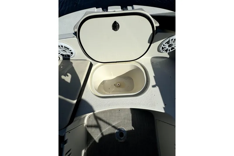 Slide: The Image of 2022 Stingray SC192 boat interior with open storage compartment and speakers. - 23