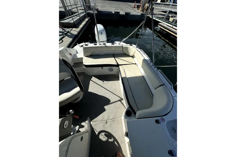 Slide: The Image of 2022 Stingray SC192 boat interior with beige seating at dock. - 28