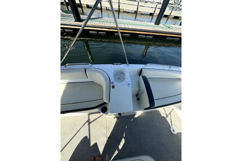 Slide: The Image of 2022 Stingray SC192 boat interior with seating and water view at dock. - 29