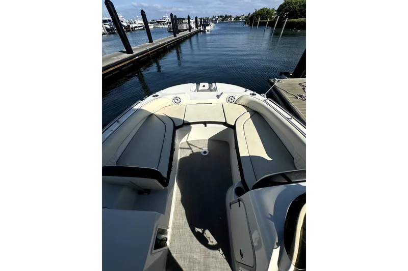 Slide: The Image of 2022 Stingray SC192 boat interior with spacious seating at marina. - 30