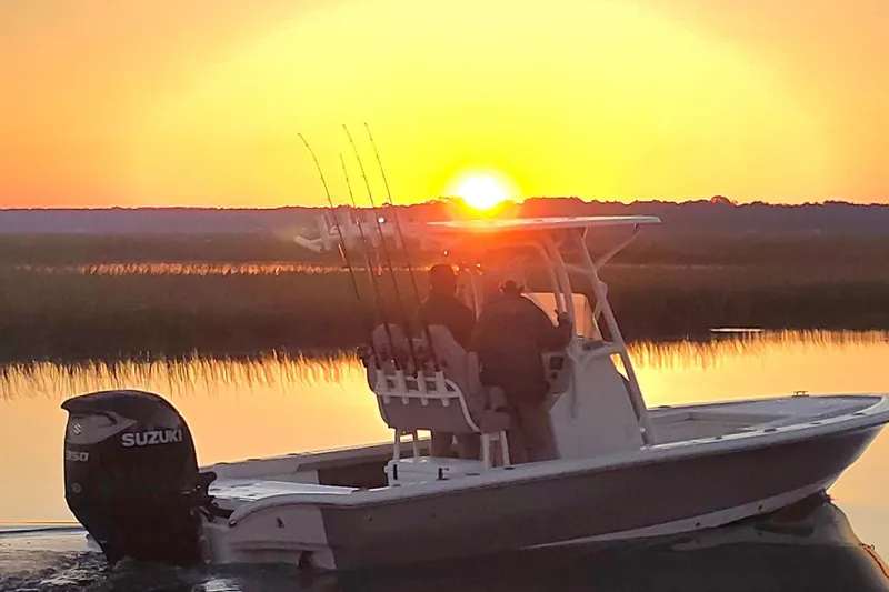 The Image of Avenger AV26 boat at sunset, 2026 model, with fishing rods and Suzuki engine. - 0