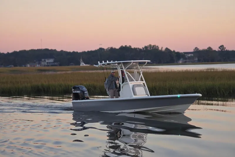 Slide: The Image of 2026 Avenger AV26 boat cruising on calm water at sunset. - 13