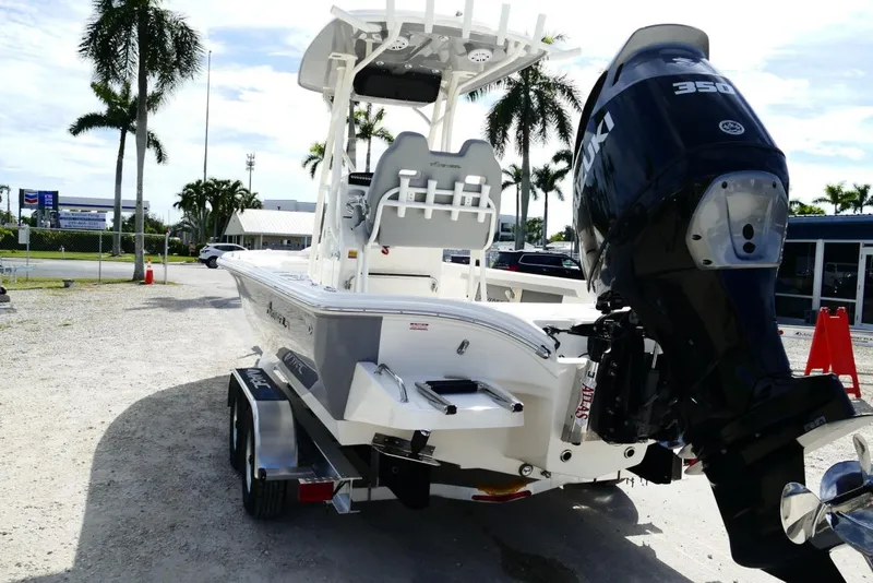 Slide: The Image of 2026 Avenger AV26 boat with Suzuki 350 engine on trailer, parked outdoors. - 18