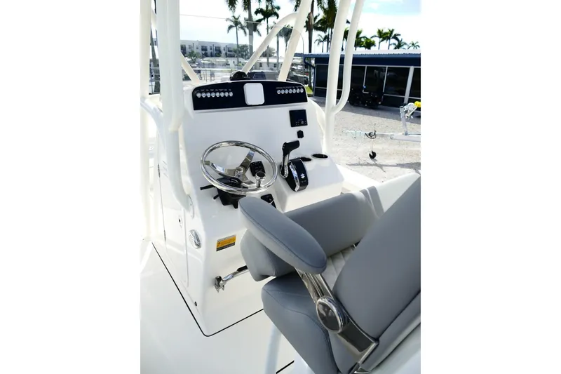 Slide: The Image of 2026 Avenger AV26 boat helm with steering wheel and control panel. - 25