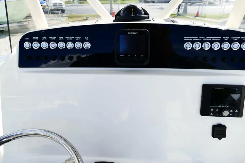 Slide: The Image of Control panel of 2026 Avenger AV26 boat with Suzuki display and JL Audio system. - 27