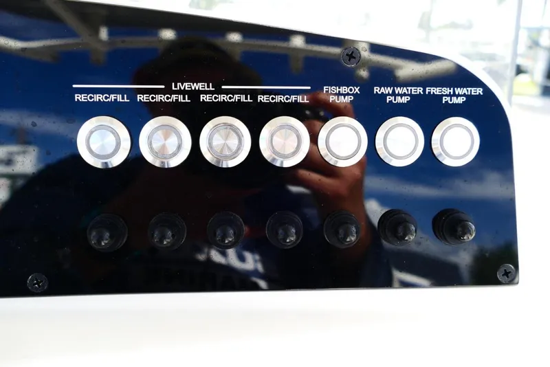 Slide: The Image of Control panel of Avenger AV26 boat, featuring livewell and water pump buttons, 2026 model. - 28