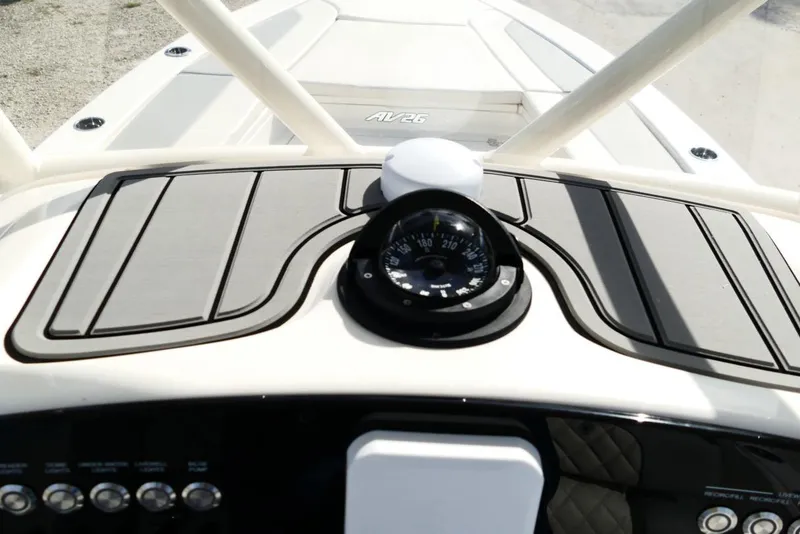 Slide: The Image of 2026 Avenger AV26 boat dashboard with compass and control panel. - 32