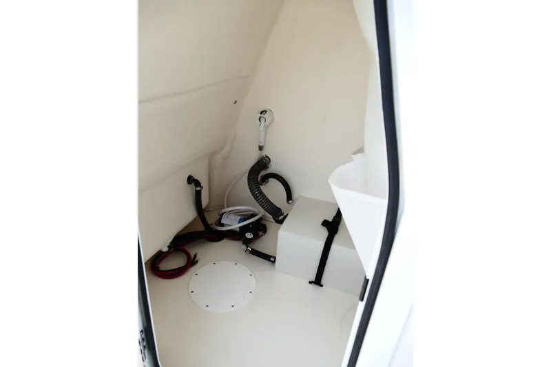 Slide: The Image of Interior of 2026 Avenger AV26 boat, featuring storage space and utility connections. - 35