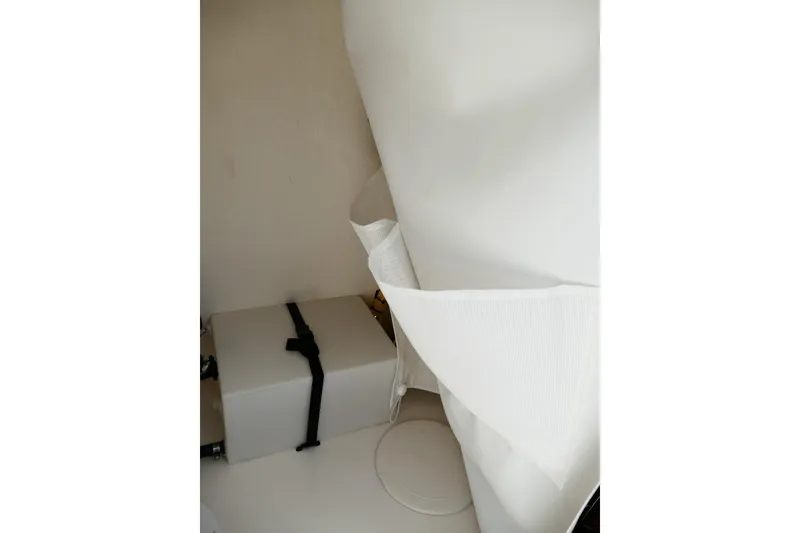 Slide: The Image of Interior of 2026 Avenger AV26, featuring storage compartment and white fabric details. - 36