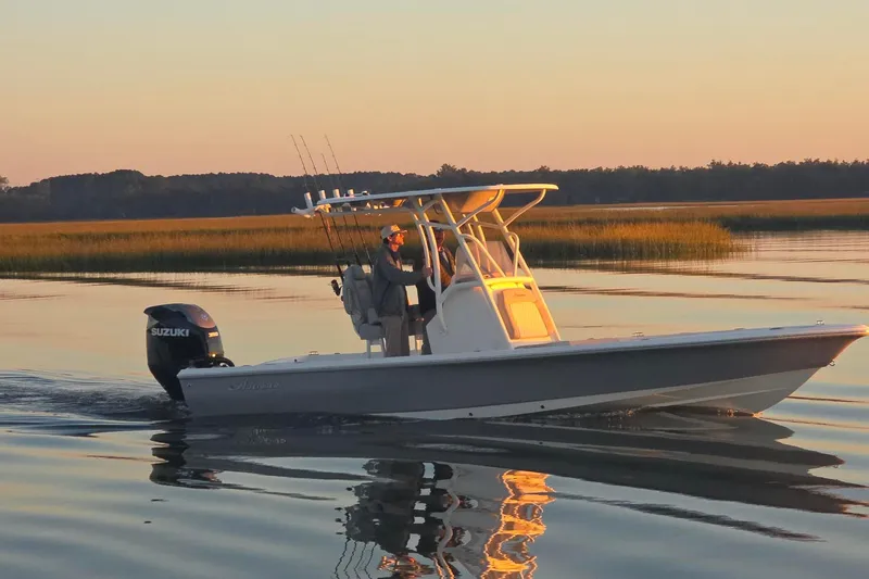 Slide: The Image of 2026 Avenger AV26 boat cruising on calm water at sunset. - 6