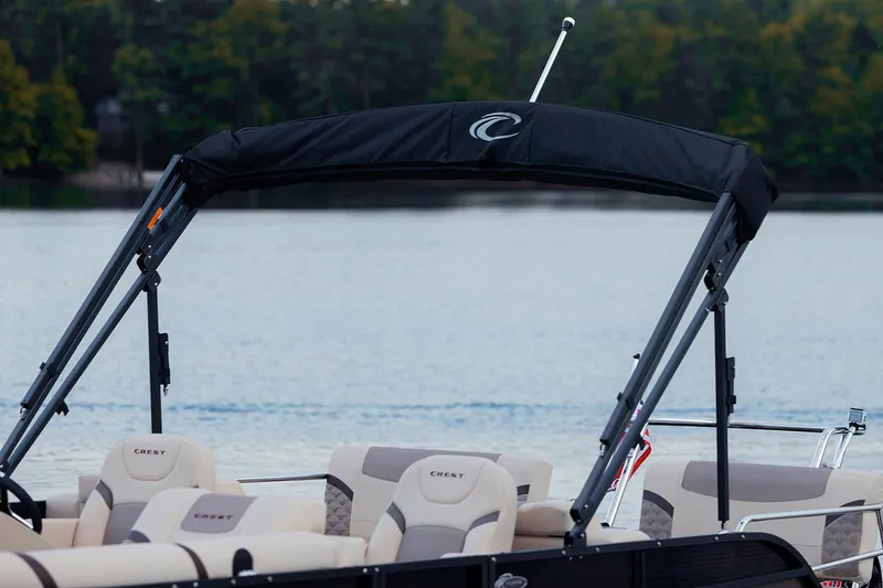 Slide: The Image of Manufacturer Provided Image: 2023 Crest Classic DLX 240 pontoon boat on a serene lake. - 5