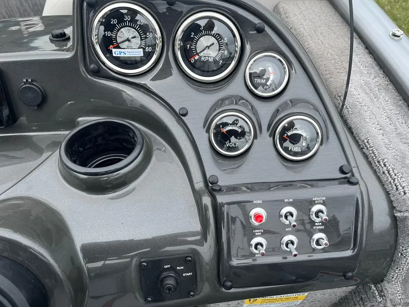 Slide: The Image of Control panel of 2025 Lowe Deck SD224 boat with gauges and switches. - 21