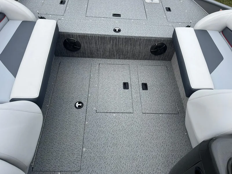 Slide: The Image of 2025 Lowe Deck SD224 boat interior with gray seating and storage compartments. - 30