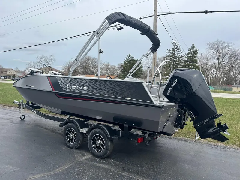 Slide: The Image of 2025 Lowe Deck SD224 boat on trailer, featuring sleek design and powerful outboard motor. - 5