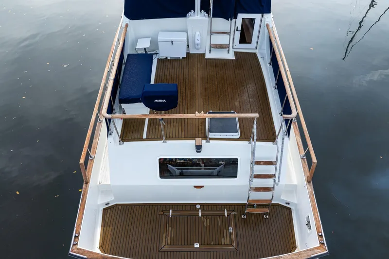 Slide: The Image of 1991 Tollycraft 48 Cockpit Motor Yacht with wooden deck and seating, viewed from above. - 11
