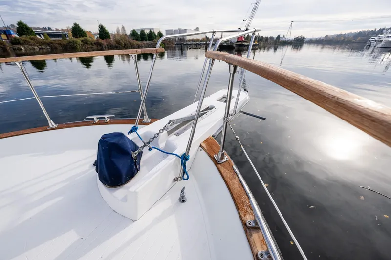 Slide: The Image of 1991 Tollycraft 48 Cockpit Motor Yacht deck with railing, docked on calm water. - 13