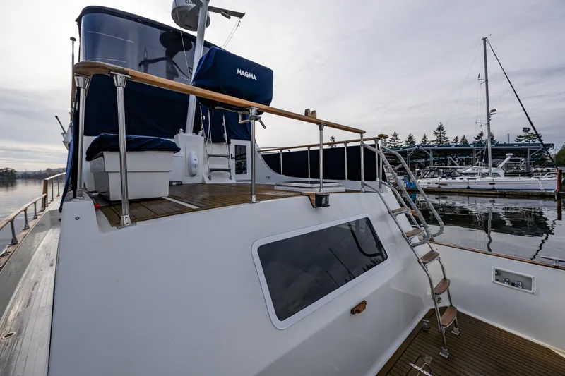 Slide: The Image of 1991 Tollycraft 48 Cockpit Motor Yacht docked, featuring spacious deck and elegant design. - 17