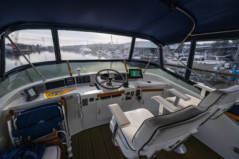 Slide: The Image of 1991 Tollycraft 48 Cockpit Motor Yacht helm with panoramic marina view. - 20