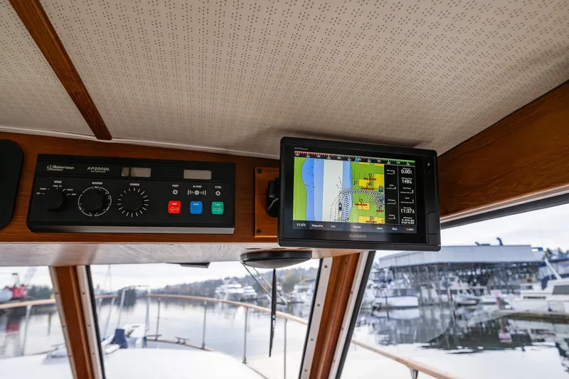 Slide: The Image of 1991 Tollycraft 48 Cockpit Motor Yacht helm with navigation system and control panel. - 24