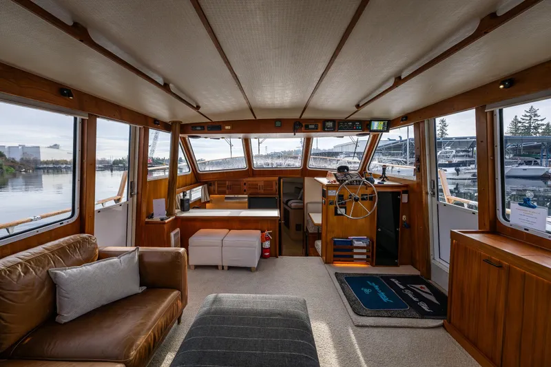 Slide: The Image of Interior of 1991 Tollycraft 48 Cockpit Motor Yacht with wood accents and waterfront view. - 28