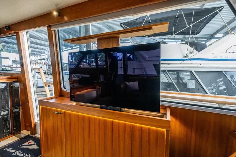 Slide: The Image of Interior of 1991 Tollycraft 48 Cockpit Motor Yacht with modern TV setup. - 29