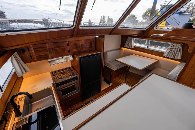 Slide: The Image of Interior of 1991 Tollycraft 48 Cockpit Motor Yacht with kitchen and dining area. - 32