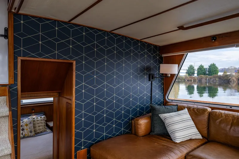 Slide: The Image of Luxurious interior of 1991 Tollycraft 48 Cockpit Motor Yacht with leather sofa and geometric wall design. - 40