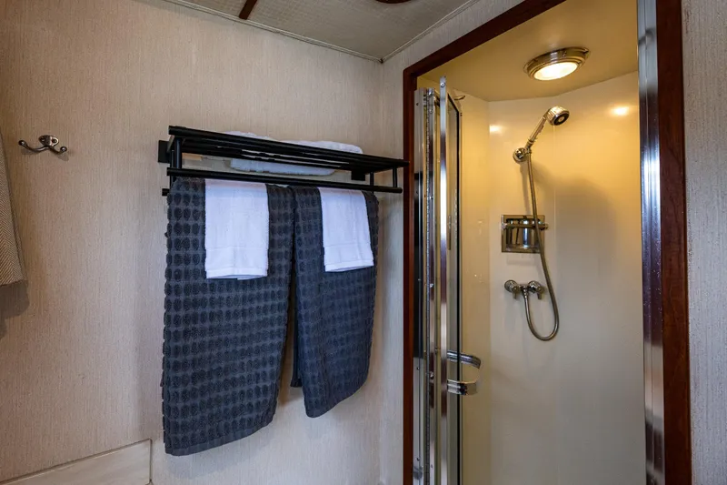 Slide: The Image of Interior of 1991 Tollycraft 48 Cockpit Motor Yacht with geometric wall design and leather seating. - 43