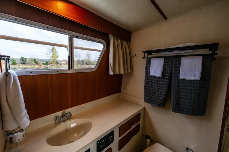 Slide: The Image of Luxurious bedroom interior of 1991 Tollycraft 48 Cockpit Motor Yacht with elegant wood finish. - 44