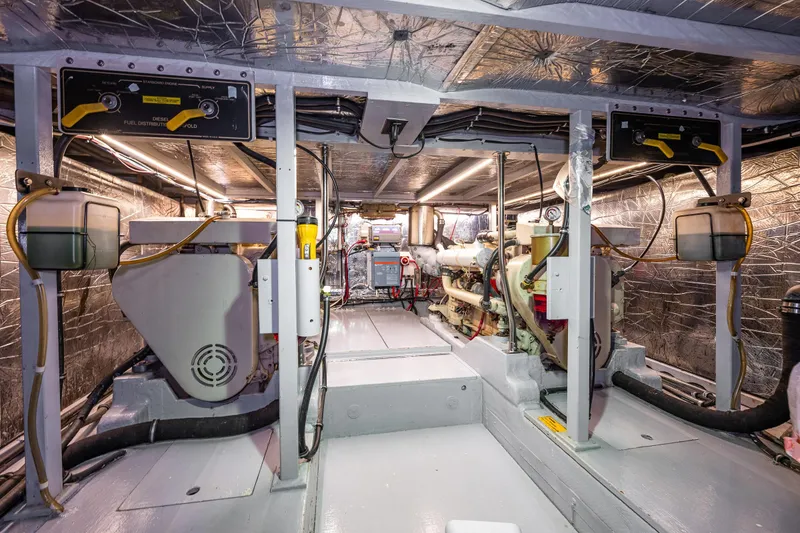 Slide: The Image of Interior of 1991 Tollycraft 48 Cockpit Motor Yacht with cozy twin beds and wooden accents. - 48