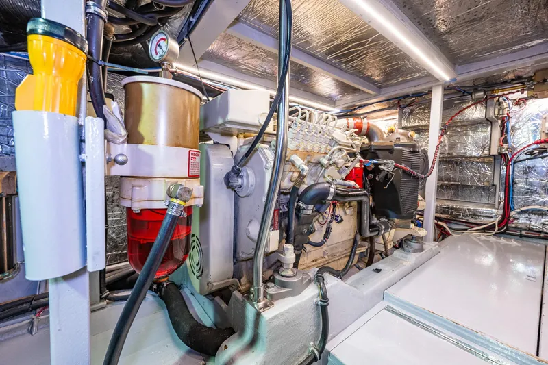 Slide: The Image of Engine room of 1991 Tollycraft 48 Cockpit Motor Yacht, showcasing dual engines and mechanical systems. - 52