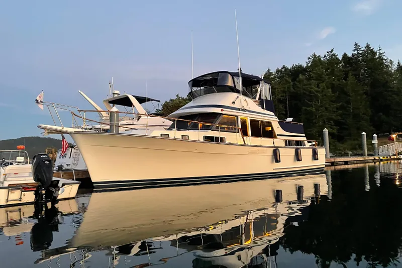 Slide: The Image of 1991 Tollycraft 48 Cockpit Motor Yacht docked at serene marina, reflecting on calm water. - 62