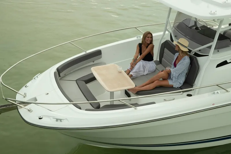 Slide: The Image of 2025 Jeanneau Leader 9.0 CC boat with two women relaxing on deck. - 4
