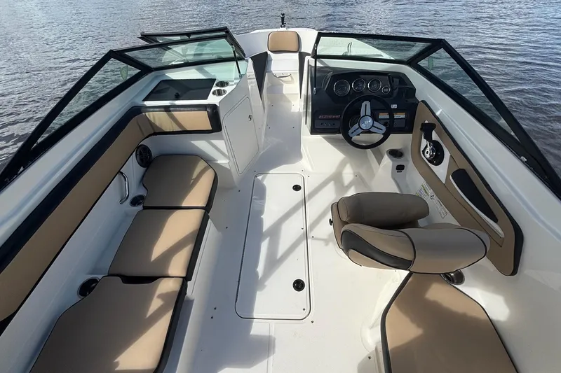Slide: The Image of 2015 Sea Ray 21 SPX OB boat interior with tan seating and steering console. - 2