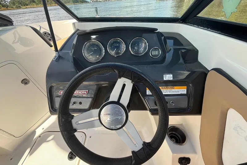 Slide: The Image of 2015 Sea Ray 21 SPX OB boat dashboard with steering wheel and gauges. - 5