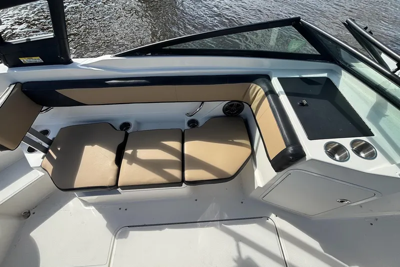 Slide: The Image of Interior seating of 2015 Sea Ray 21 SPX OB boat with tan cushions and black accents. - 6