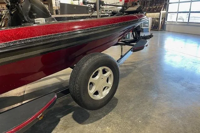 Slide: The Image of 2003 Ranger 185 VX boat on trailer in showroom, red and black design. - 1