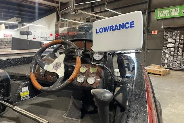 Slide: The Image of 2003 Ranger 185 VX boat dashboard with Lowrance fishfinder and wooden steering wheel. - 10