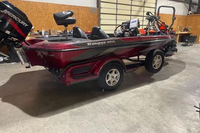 Slide: The Image of 2003 Ranger 185 VX boat in a garage, featuring a Mercury outboard motor. - 3