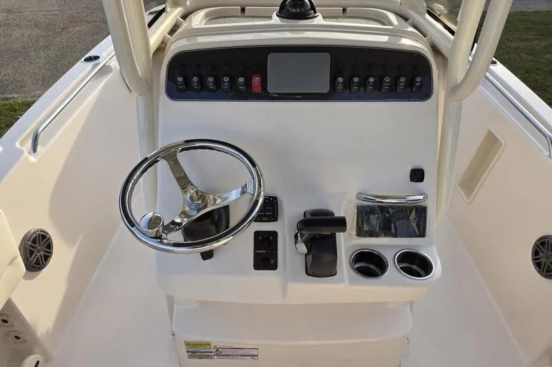 Slide: The Image of 2026 Grady-White Fisherman 216 boat console with steering wheel and controls. - 12