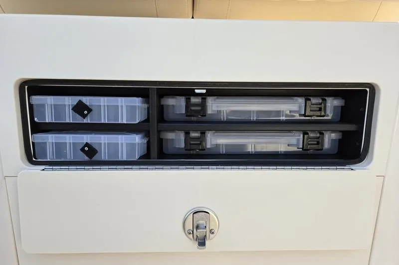 Slide: The Image of Storage compartment with tackle boxes on a 2026 Grady-White Fisherman 216 boat. - 16