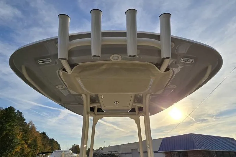 Slide: The Image of 2026 Grady-White Fisherman 216 boat, viewed from below, showcasing rod holders and T-top. - 18