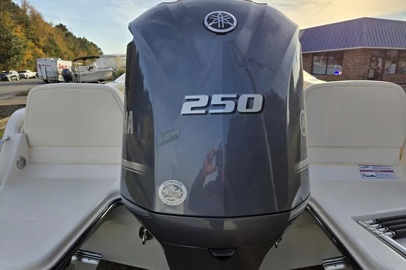 Slide: The Image of 2026 Grady-White Fisherman 216 with Yamaha 250 outboard motor, parked outdoors. - 4