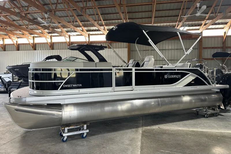 The Image of 2026 Godfrey SW 2286 SFL pontoon boat in a warehouse setting. - 1